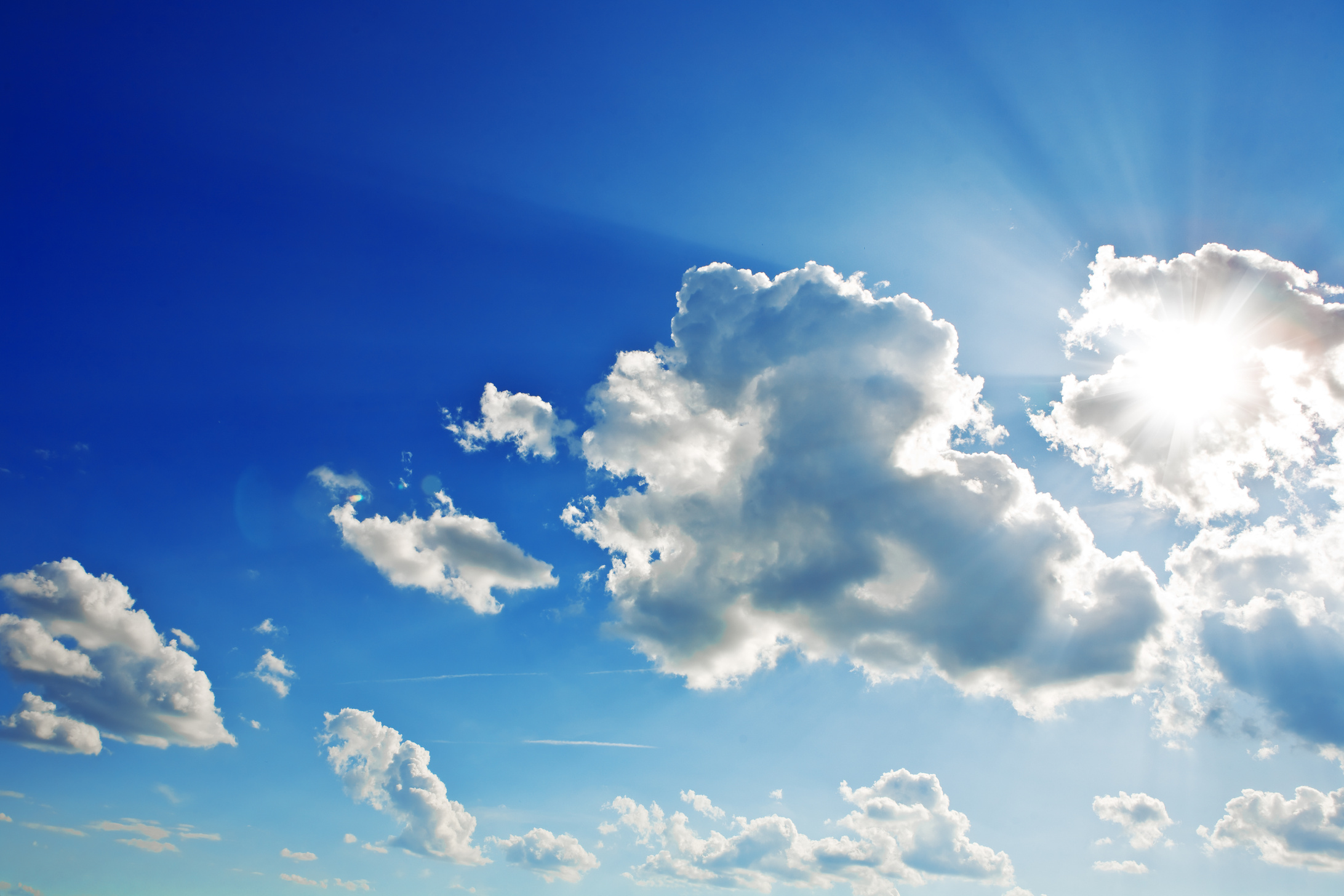 sun looks out from for clouds